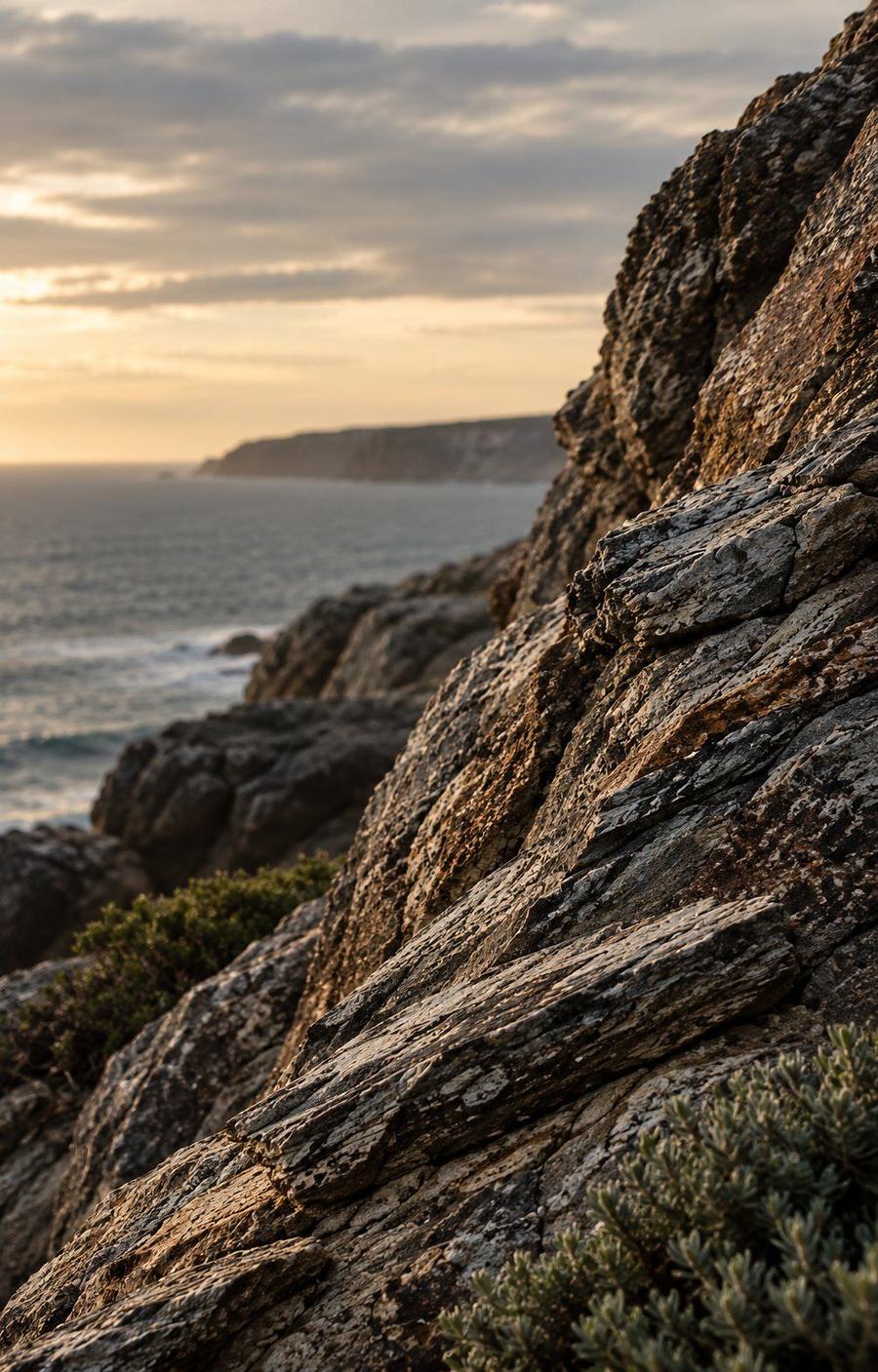 Weathered coastal rock above the ocean at dusk